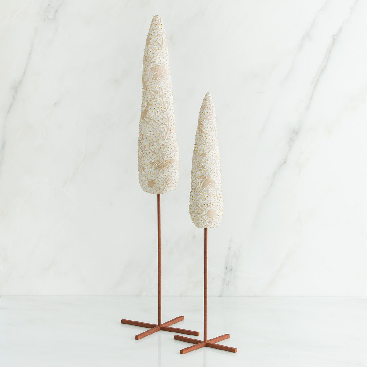 Set of two white tree figurines with wooden stands - all white background