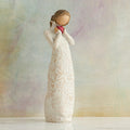 Willow Tree Je t'aime (I Love You), 8.5"h hand-painted standing resin figure holding red heart in cream dress with ruffled neck and carved with hearts, flowers and birds, in front of muted painting