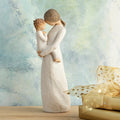 Willow Tree Tenderness, 8”h hand-painted standing resin figure holding toddler, foreheads touching, both dressed in cream, in front of blue painting