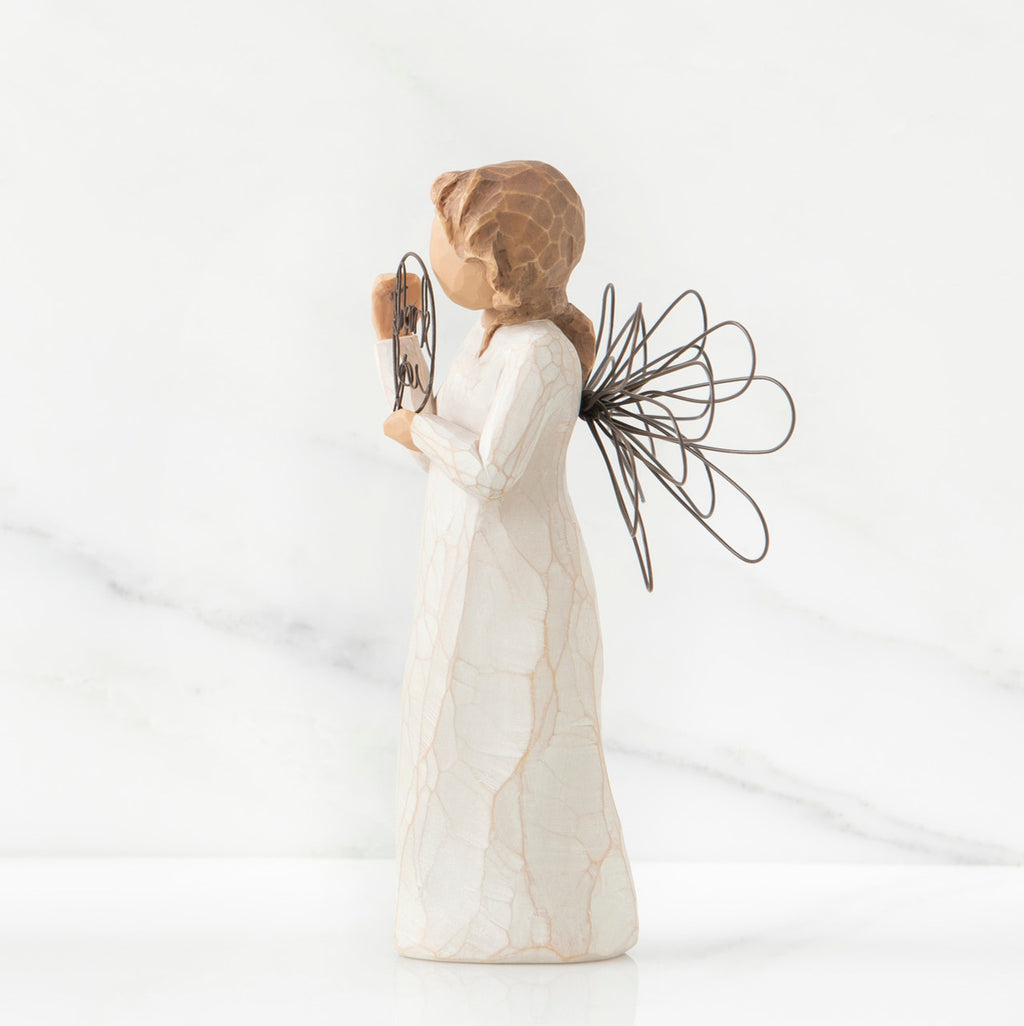 Right side view of angel with tied back brown hair, holding up a circular wire sign that says "thank you"