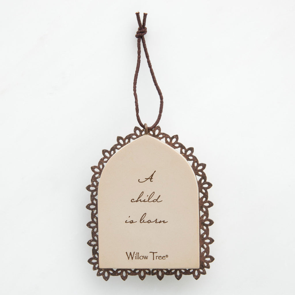 Round cream pendant with wooden outline - center says 'a child is born'