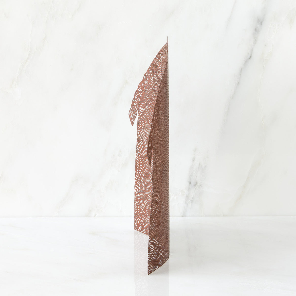 Brown figurine standing up against white background