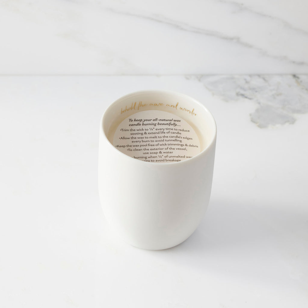 Top view of candle with vellum insert sheet with burning instructions