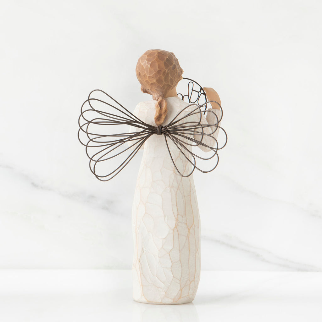 Back view of angel with tied back brown hair, holding up a circular wire sign that says "thank you"