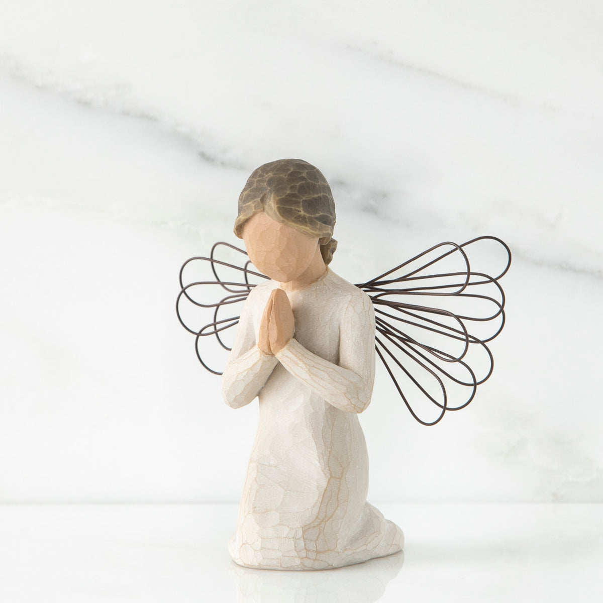Small faceless girl kneeling praying with black wire angel wings