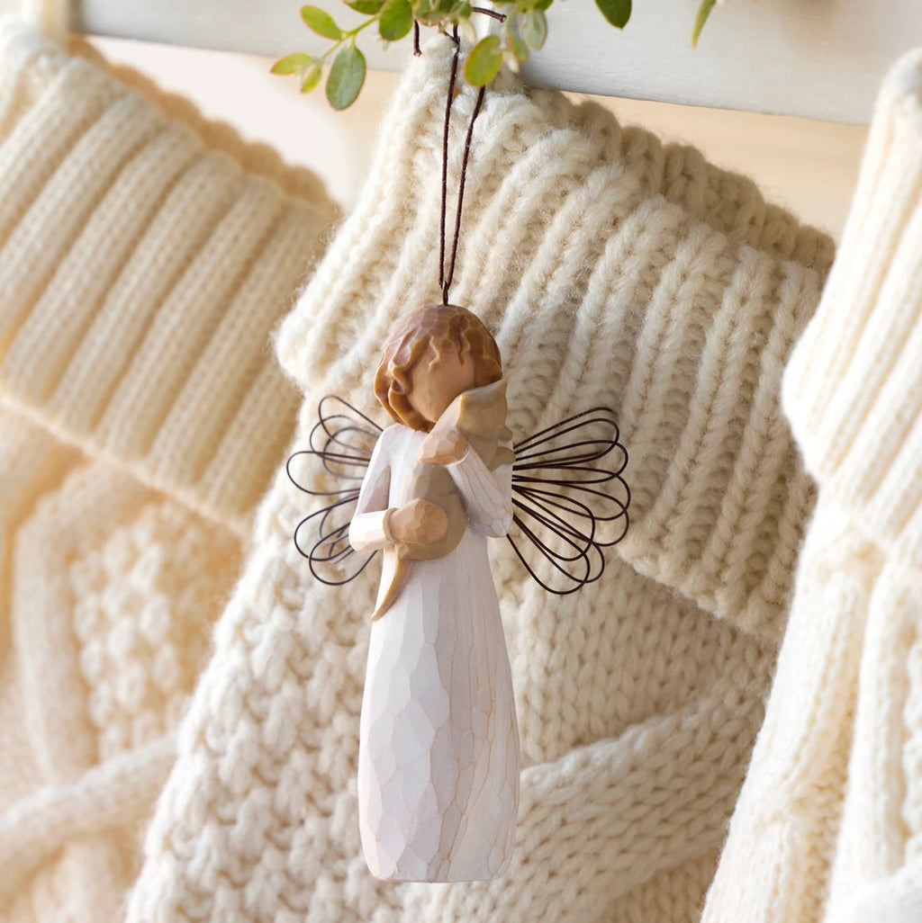 Willow Tree With affection Ornament, 4.5”h hand-painted resin figure in cream dress with wire wings, holding gray cat, brown elastic cord, hanging with cream knitted Christmas stockings