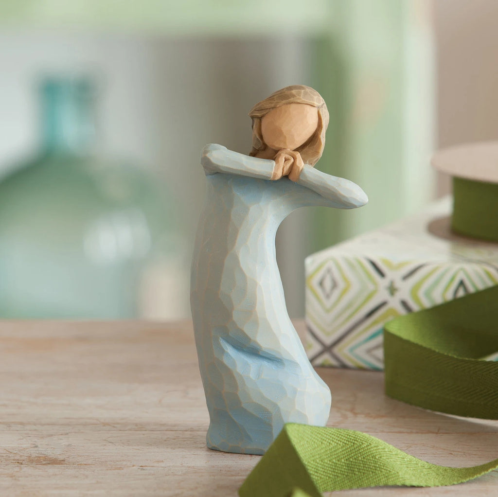 Willow Tree Journey, 5.5”h hand-painted standing resin figure in blue dress, arms raised up to face as if dancing, on wooden desk
