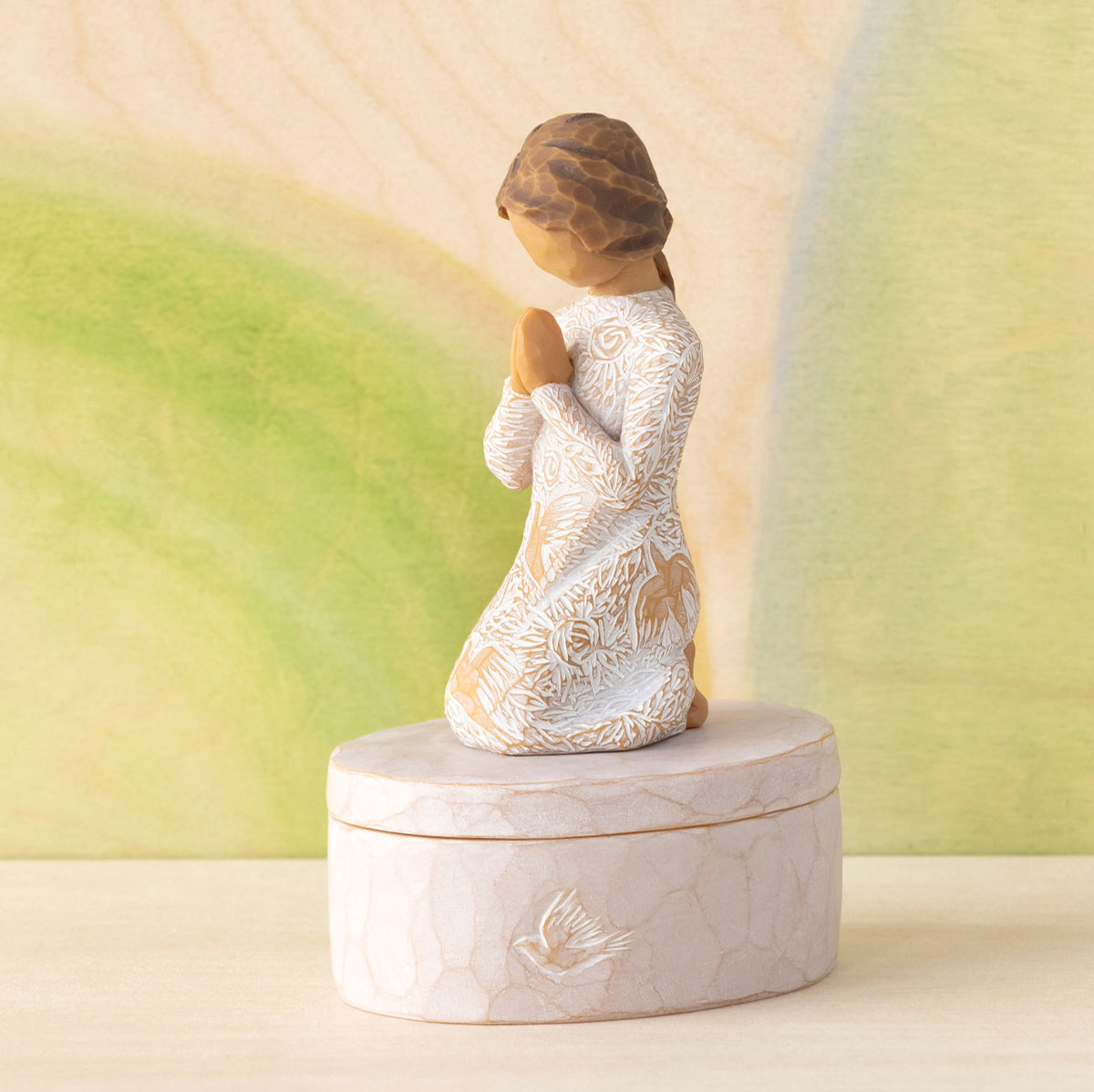 Willow Tree Prayer of Peace Keepsake Box, 3.5"oval hand-painted resin box with 3”H kneeling figure in cream dress carved with nature imagery, in prayer/meditation pose, affixed to lid, in front of green painting
