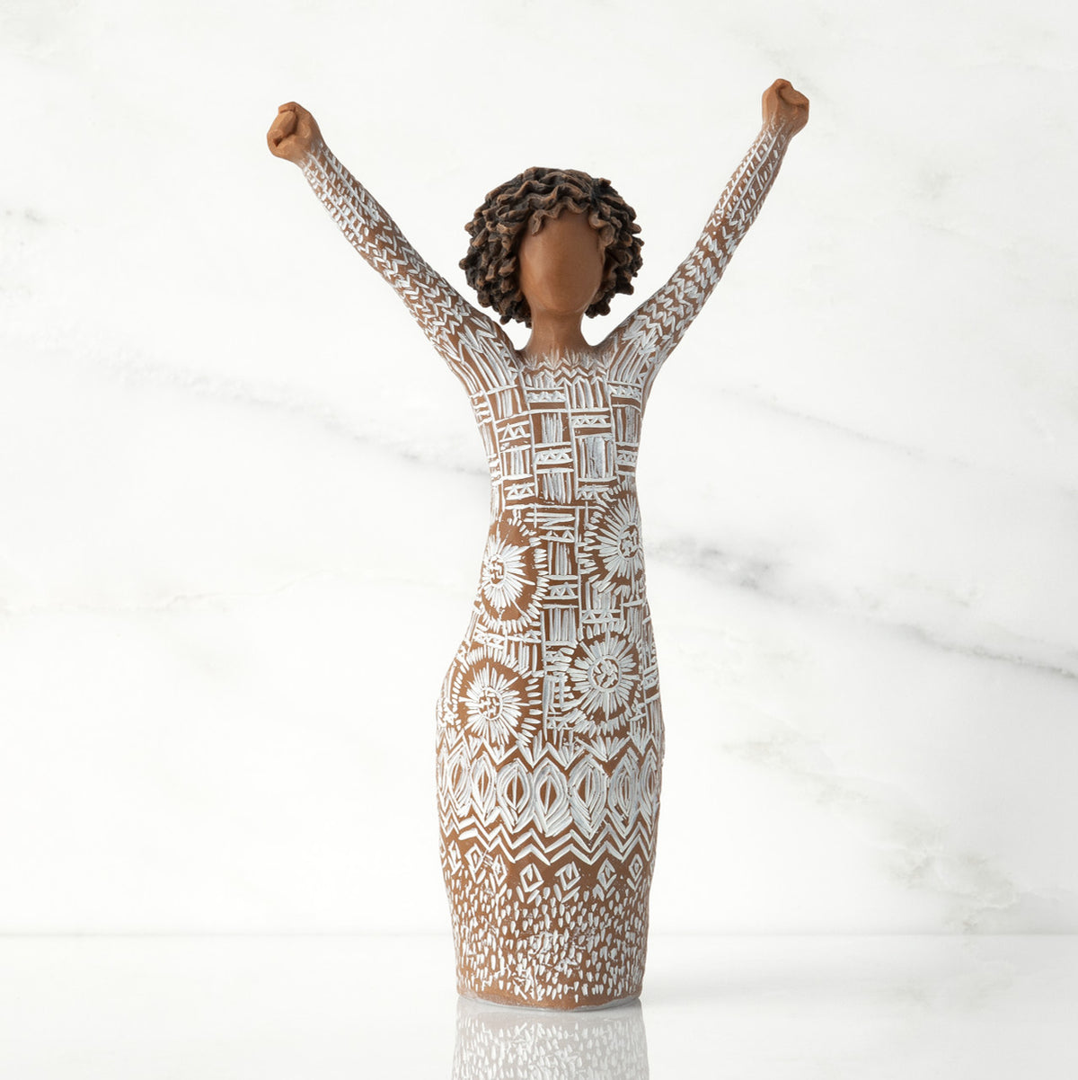 Front view of figure with natural hairstyle, arms raised overhead, dress etched with African textile patterns